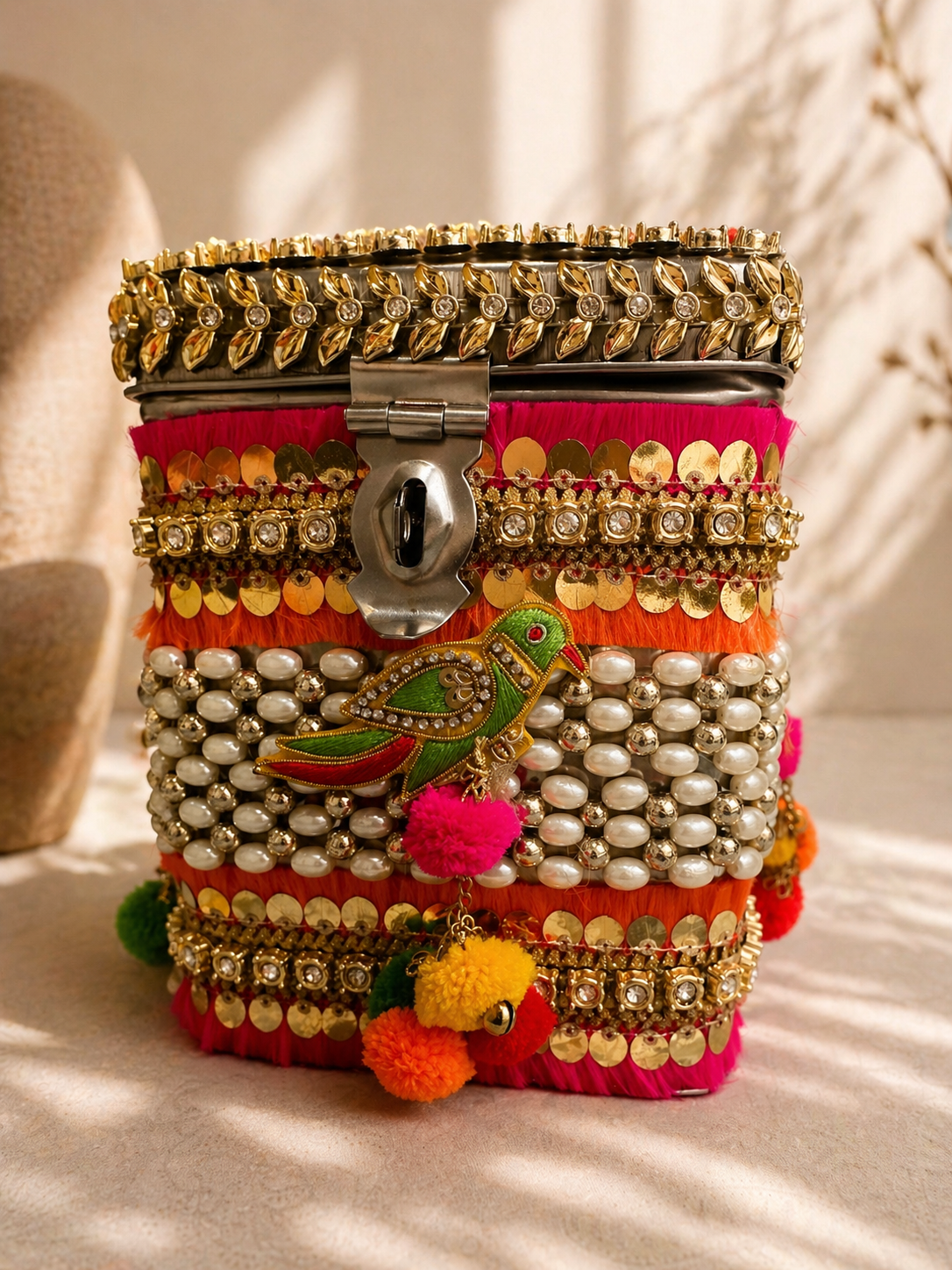 Colourful embellished wedding gifting trunk with pearls and pom poms